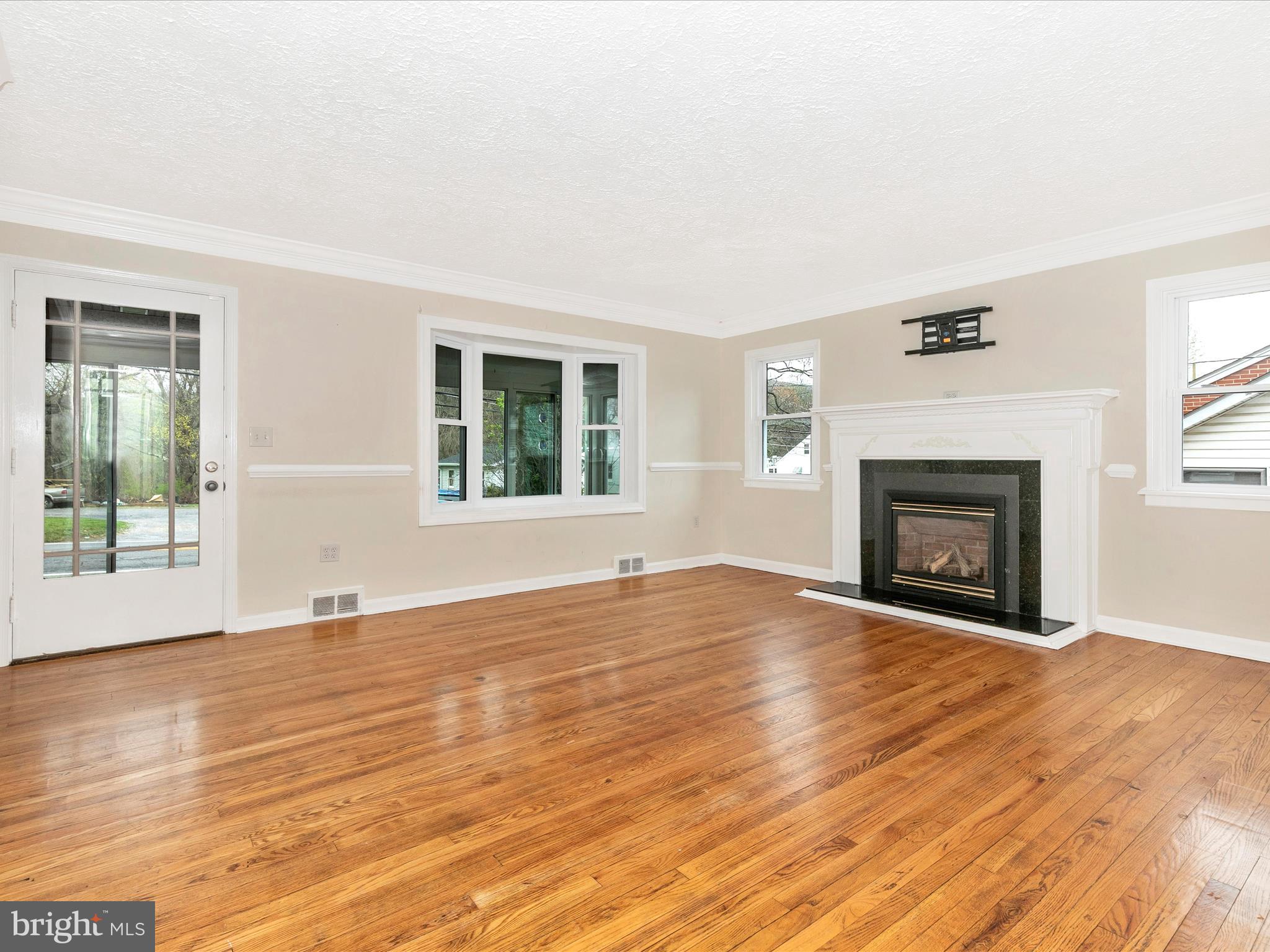 8913 Yellow Springs Road Frederick, MD 21702 - Photo 2 of 77 wooden floor fireplace and windows in an empty room
