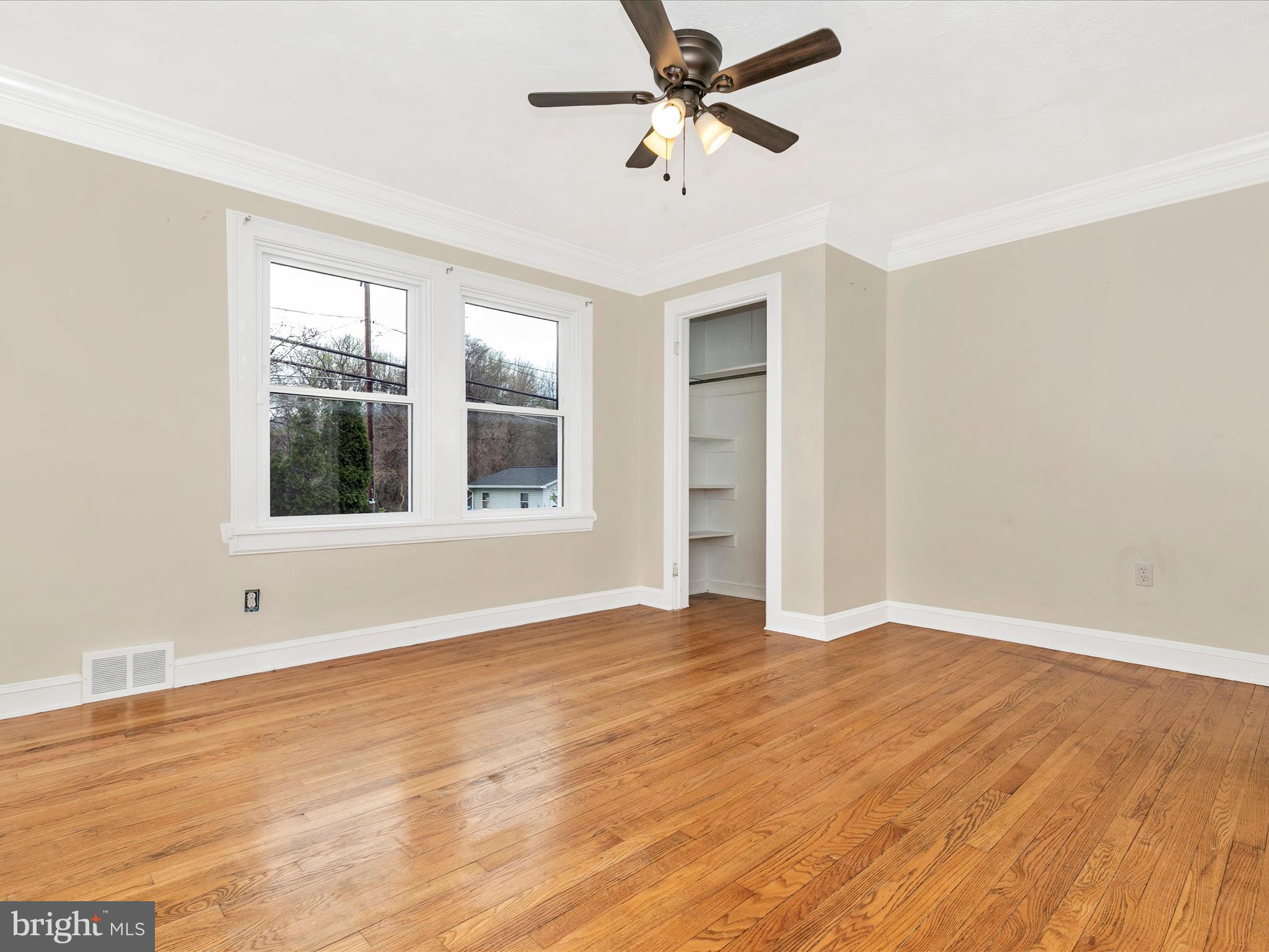 8913 Yellow Springs Road Frederick, MD 21702 - Photo 21 of 77 a view of empty room with wooden floor and fan