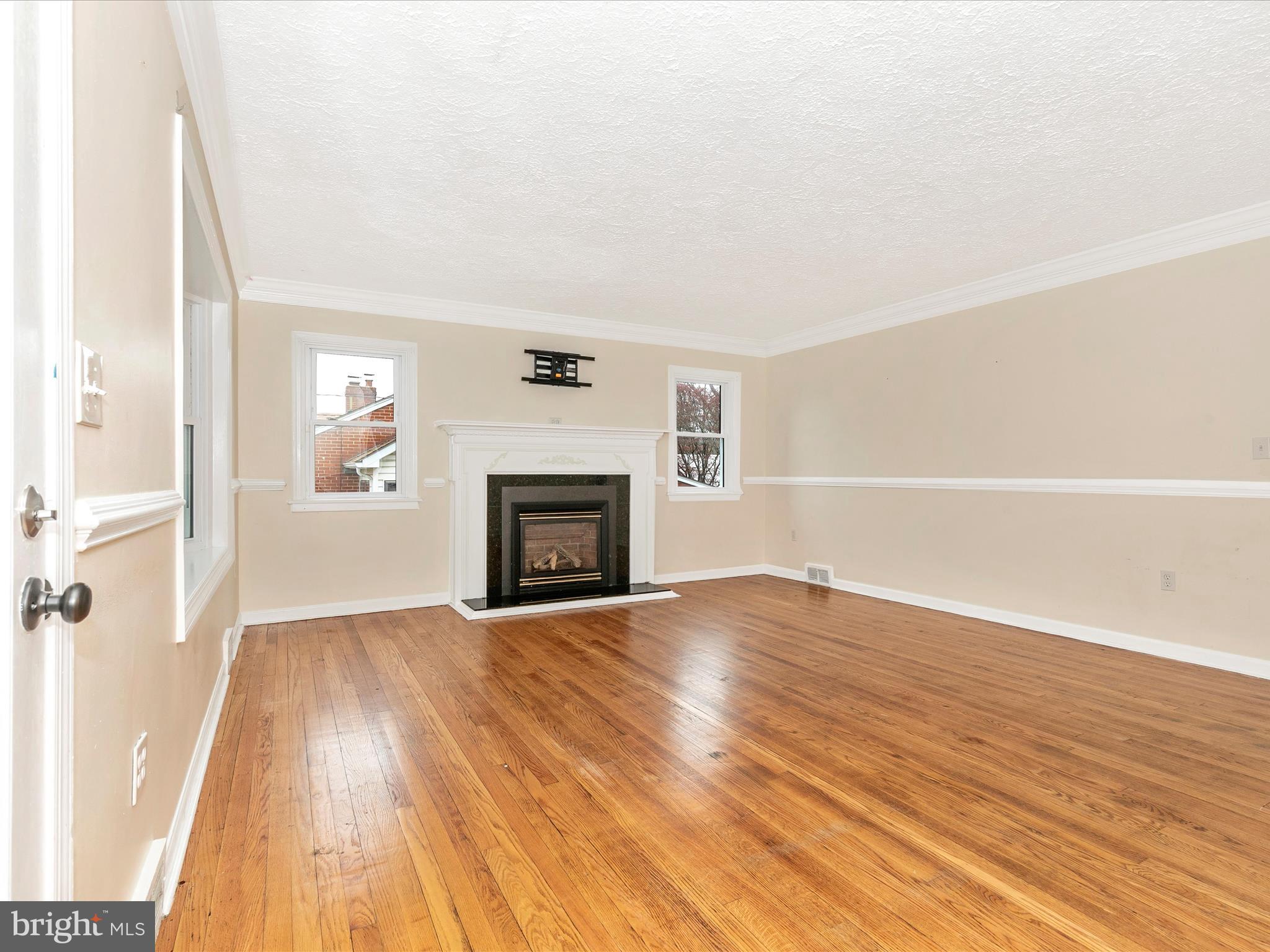 8913 Yellow Springs Road Frederick, MD 21702 - Photo 3 of 77 a view of empty room with wooden floor and fireplace