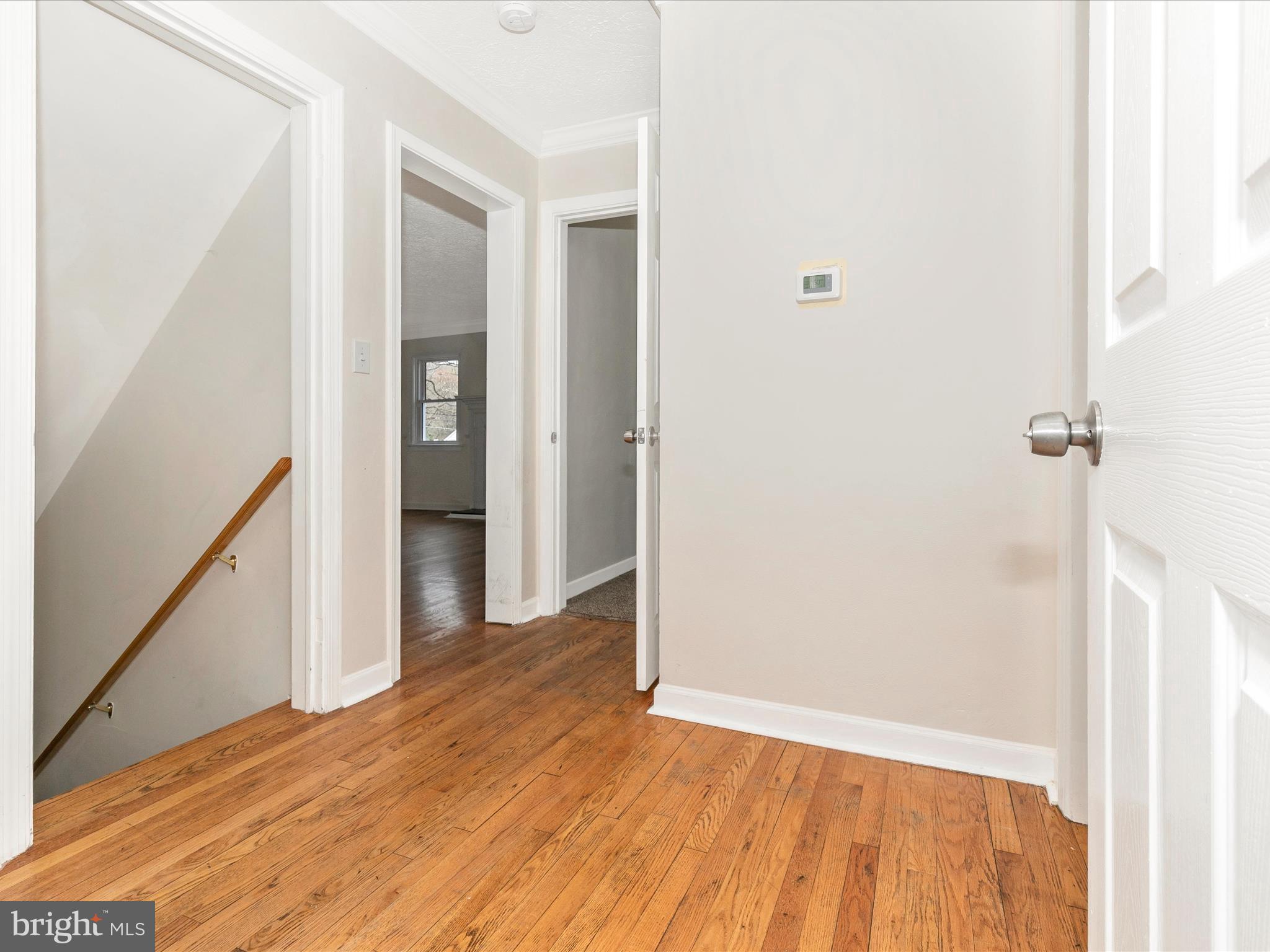 8913 Yellow Springs Road Frederick, MD 21702 - Photo 34 of 77 a view of a hallway with wooden floor and staircase