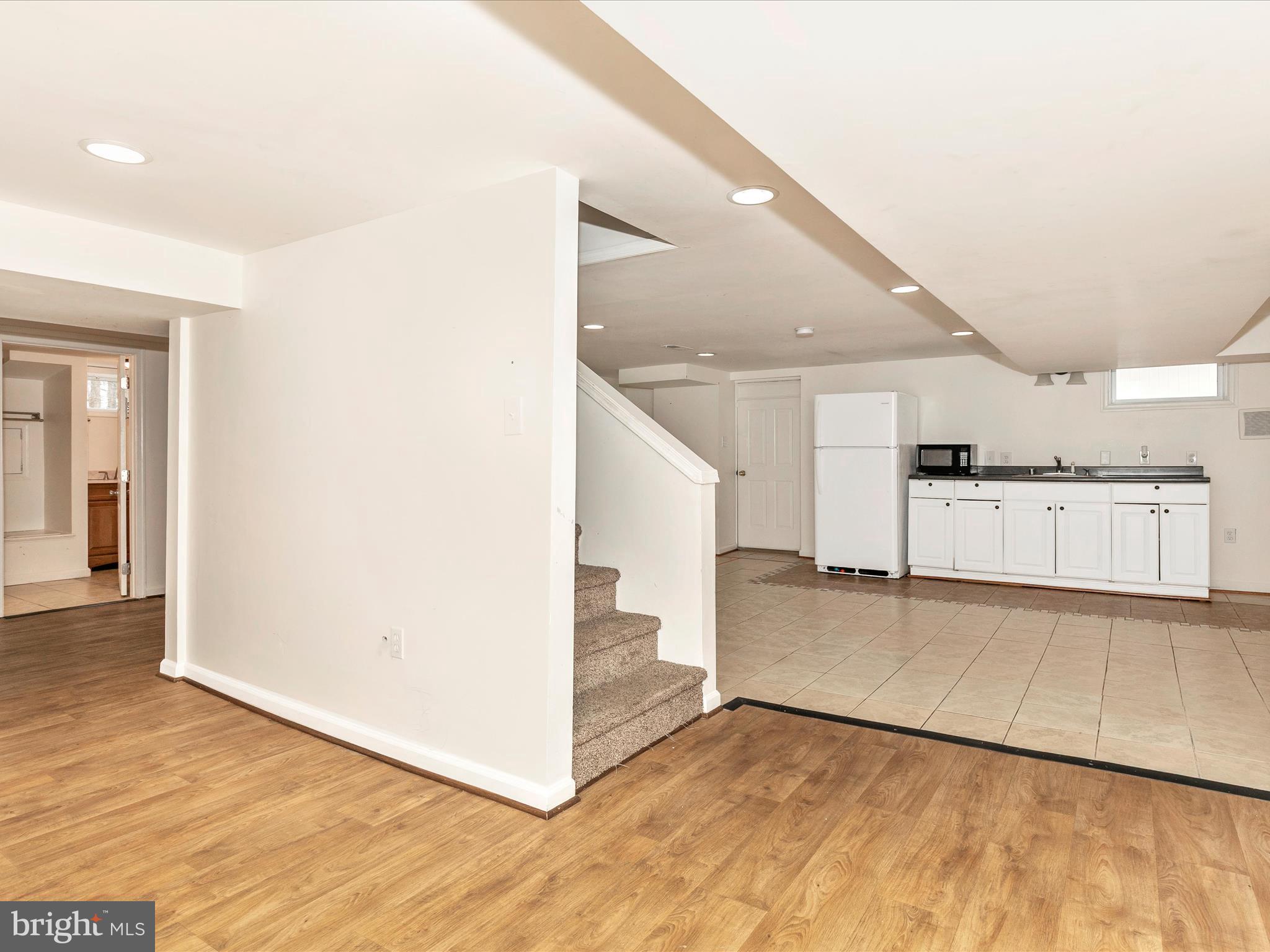 8913 Yellow Springs Road Frederick, MD 21702 - Photo 43 of 77 a view of a kitchen with white cabinets and wooden floor