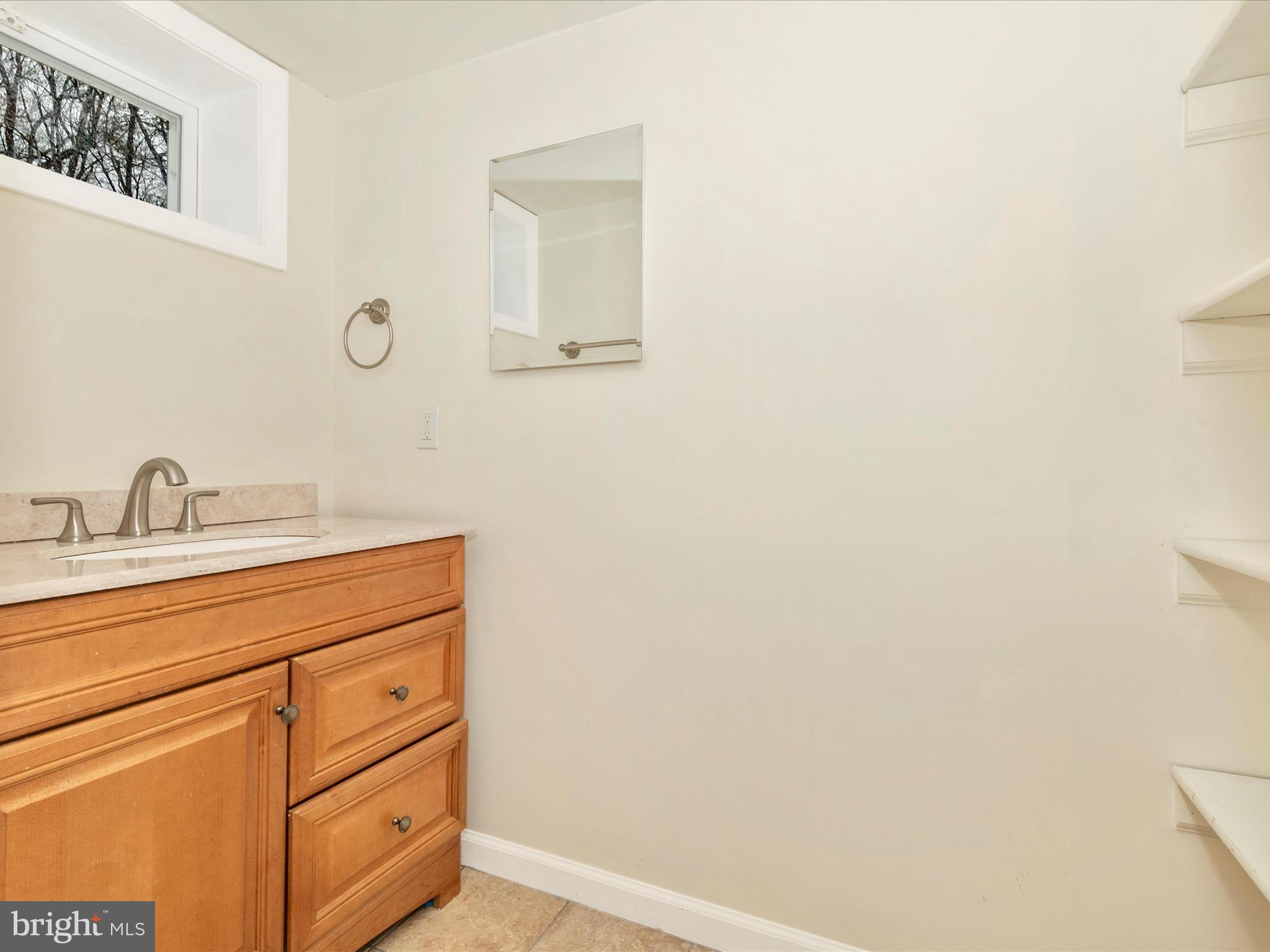 8913 Yellow Springs Road Frederick, MD 21702 - Photo 48 of 77 a bathroom with a sink and a mirror