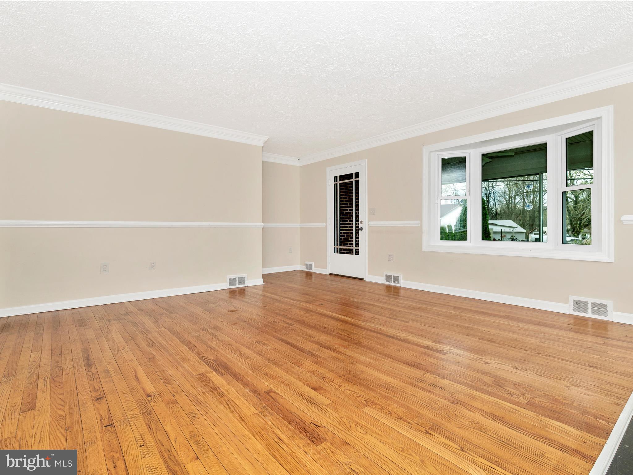 8913 Yellow Springs Road Frederick, MD 21702 - Photo 5 of 77 a view of empty room with wooden floor and fan