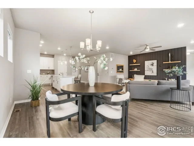 a dining room with furniture and wooden floor