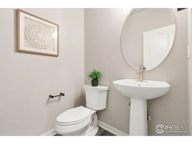 a bathroom with a toilet a sink and a mirror
