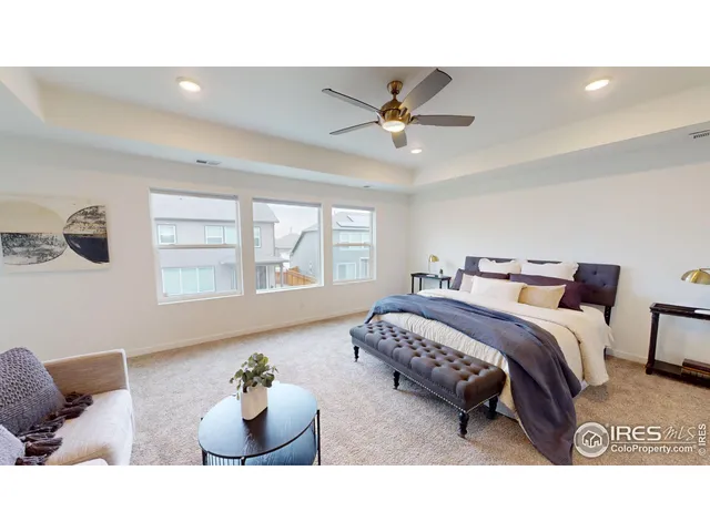 a spacious bedroom with a bed and window