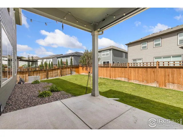 a view of a backyard with plants and lake view