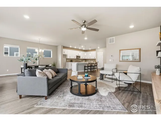 a living room with furniture and kitchen view