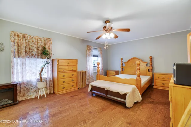 a bedroom with a bed and a tv