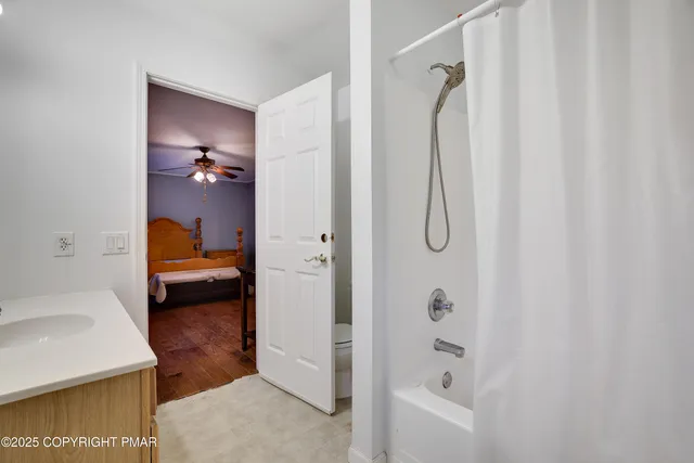 a en suite bathroom with a granite countertop sink and a mirror