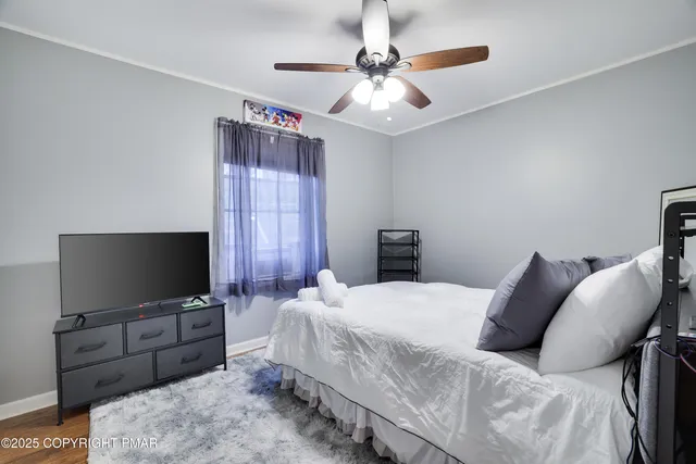 a bedroom with a bed and a flat screen tv