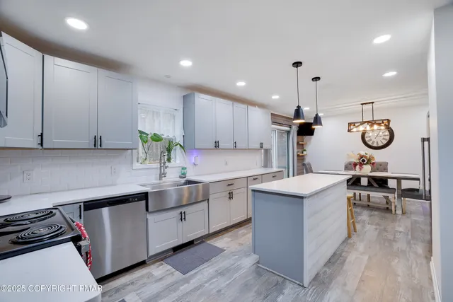 a kitchen with cabinets a sink and appliances