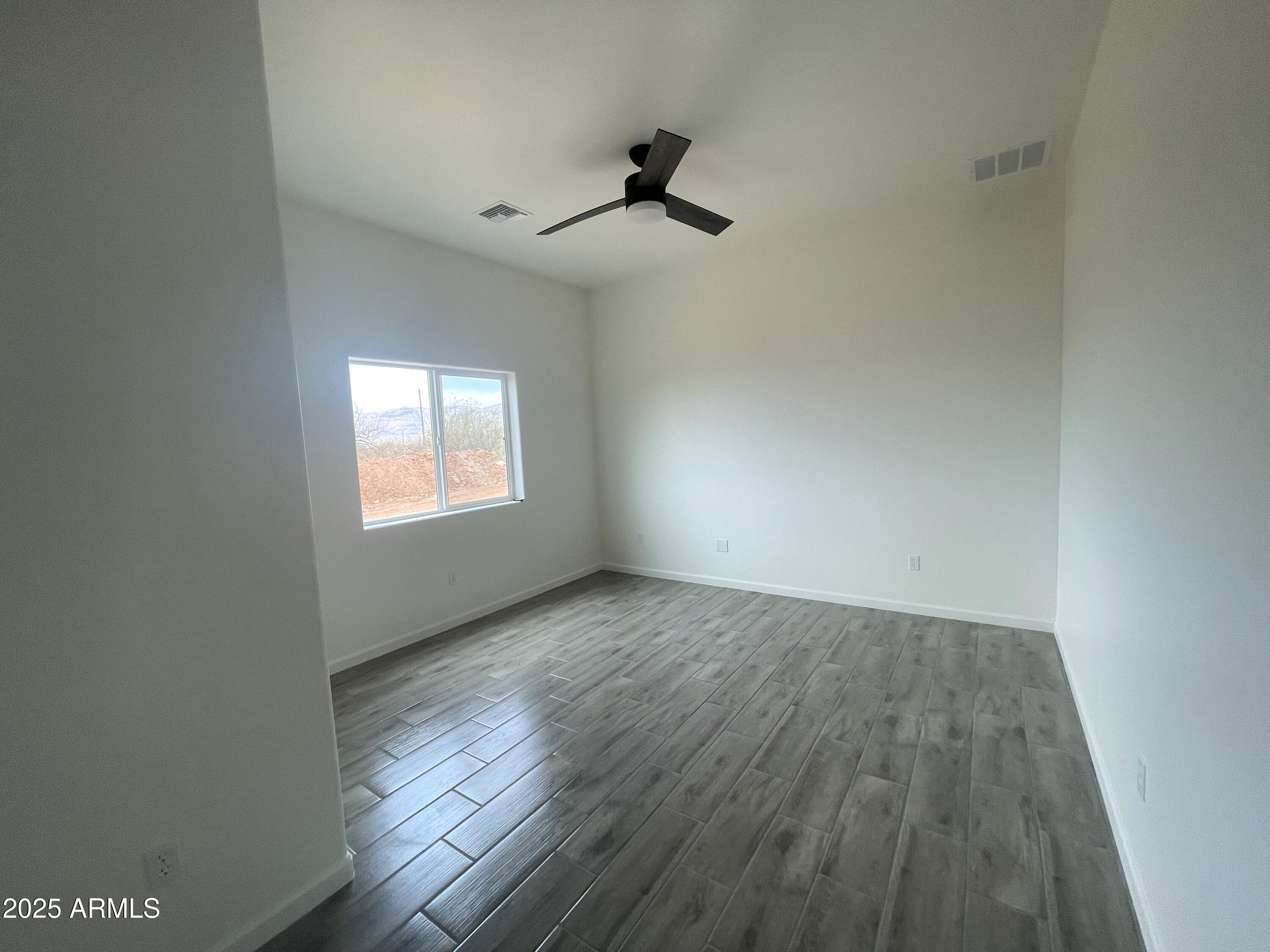 1825 Via Nueva Zelandia Rio Rico, AZ 85648 - Photo 12 of 20 wooden floor in an empty room with a window