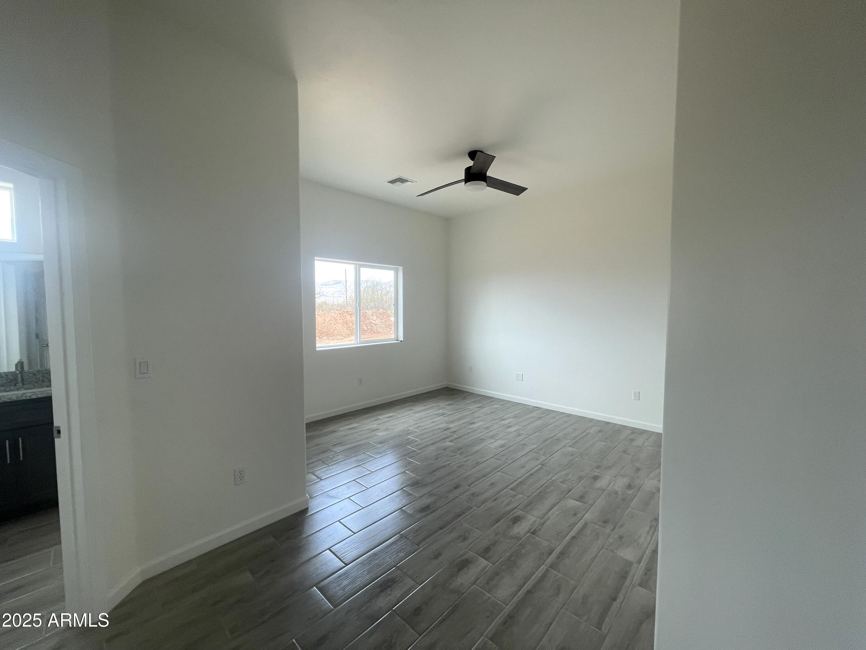 1825 Via Nueva Zelandia Rio Rico, AZ 85648 - Photo 13 of 20 an empty room with wooden floor and windows