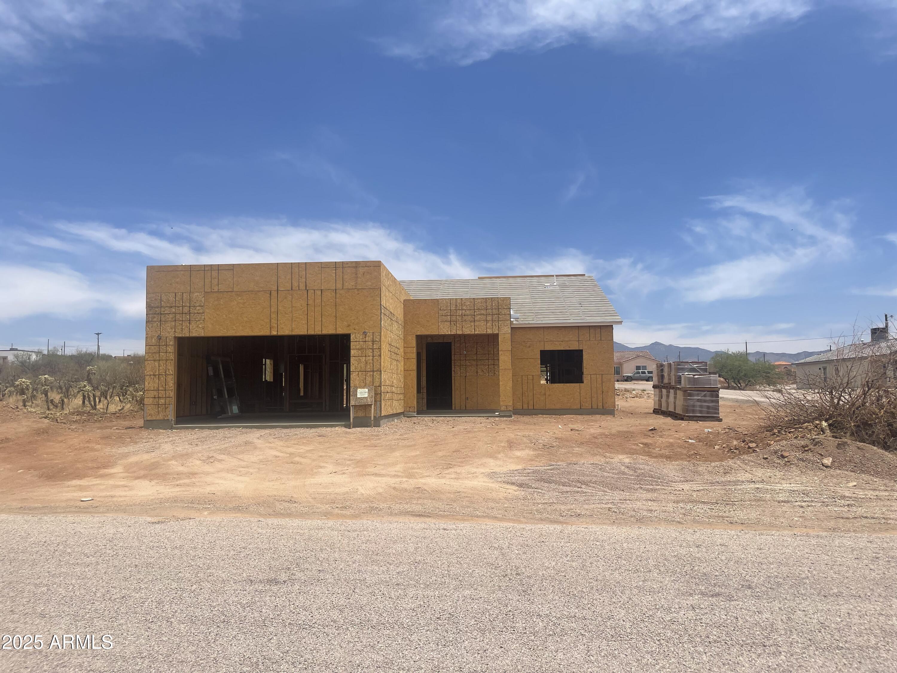 1825 Via Nueva Zelandia Rio Rico, AZ 85648 - Photo 3 of 20 a view of a house with a snow in front of yard
