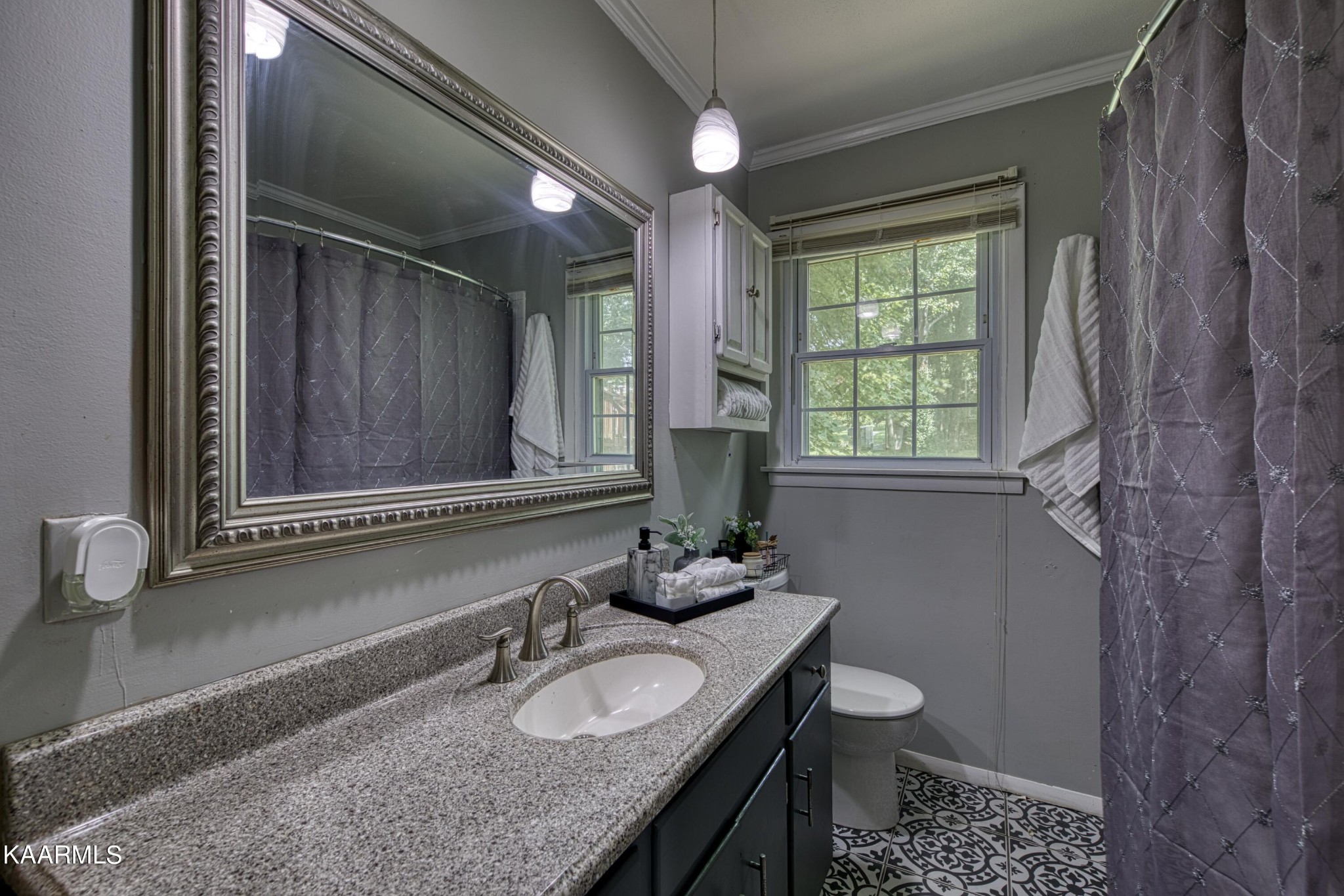 4513 Crestfield Road Knoxville, TN 37921 - Photo 18 of 33 a bathroom with a granite countertop toilet a sink and a mirror