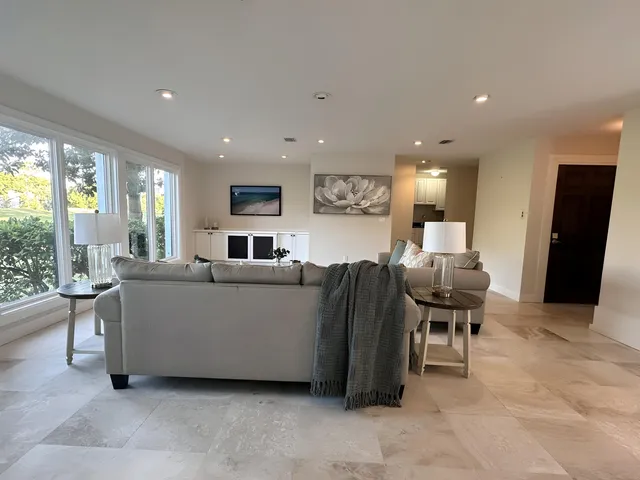 a kitchen with stainless steel appliances granite countertop a sink and a refrigerator
