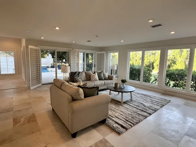 a kitchen with stainless steel appliances granite countertop wooden cabinets counter space and a center island
