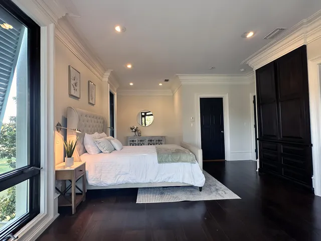 a kitchen with stainless steel appliances granite countertop a sink a stove and a wooden floors