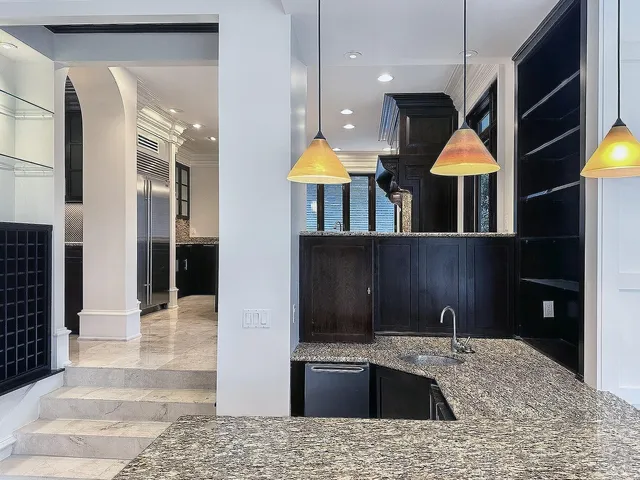 an empty room with wooden floor closet and windows