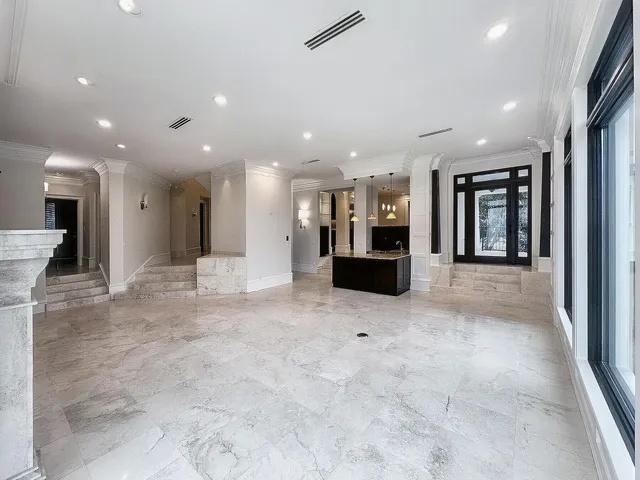 an aerial view of a house with a yard and seating space