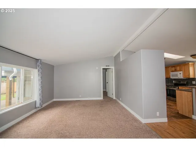 a view of a kitchen with wooden floor and a kitchen
