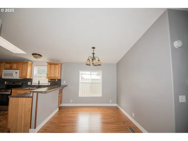 a view interior of kitchen and hall with wooden floor