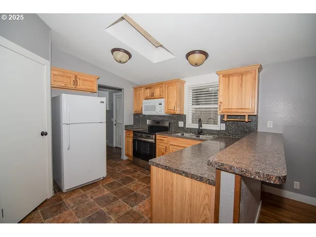 a kitchen with a sink window and cabinets