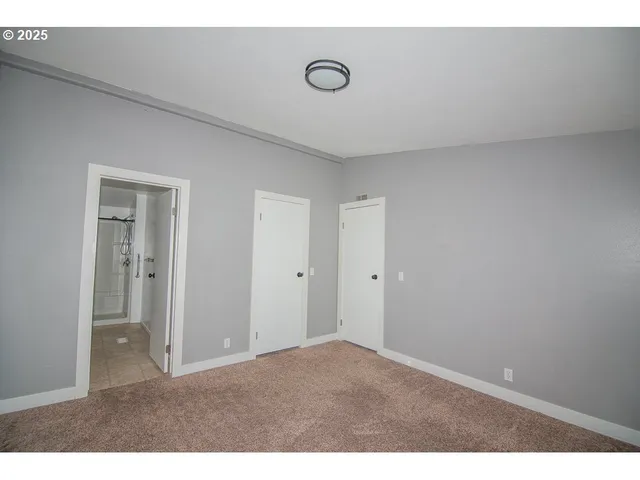a bathroom with a granite countertop bathtub shower sink vanity and a toilet