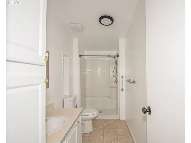 a bathroom with a toilet a sink and a shower