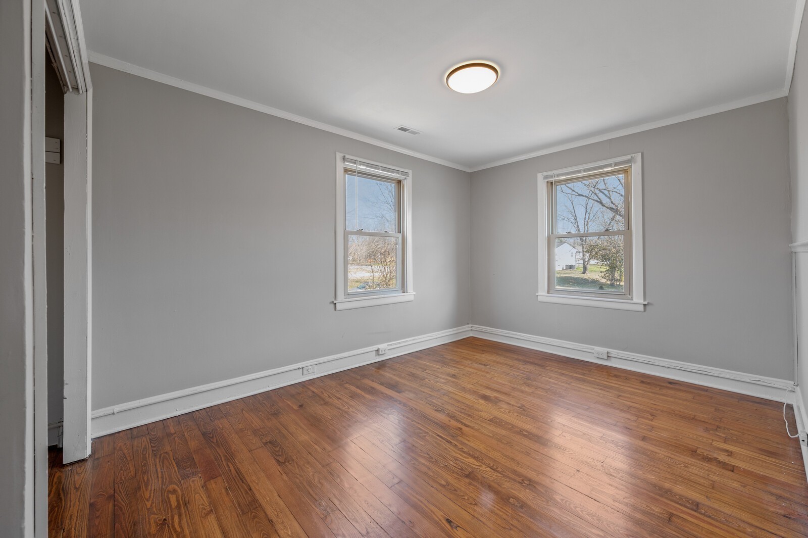 1110 Fowler Street Old Hickory, TN 37138 - Photo 11 of 16 an empty room with wooden floor and windows