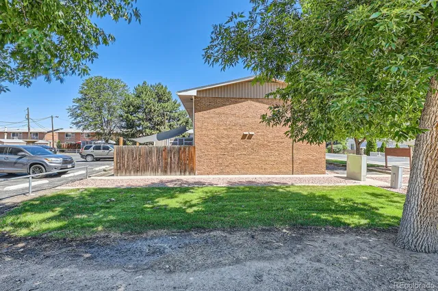 a backyard of a house with table and chairs
