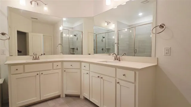 a bathroom with double sink and a mirror