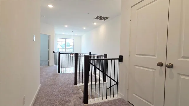 a view of a hallway with windows