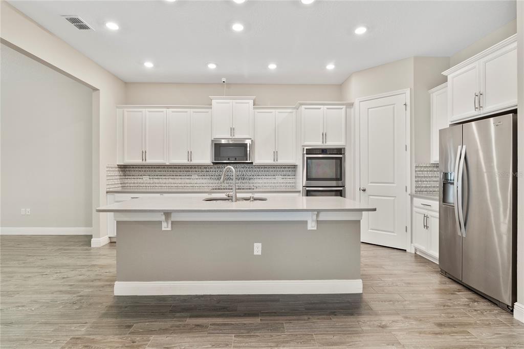 8764 Powder Ridge Trail Windermere, FL 34786 - Photo 13 of 43 a view of kitchen with stainless steel appliances granite countertop a stove and a refrigerator