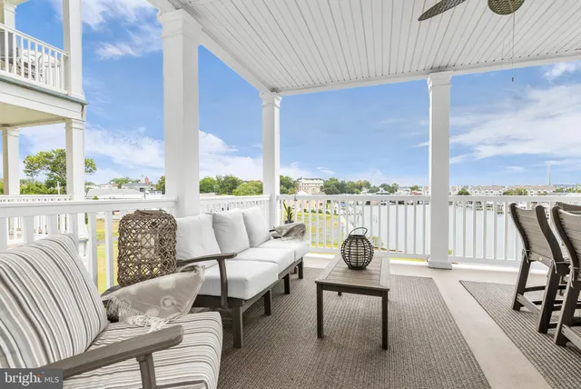 a living room with furniture and floor to ceiling windows