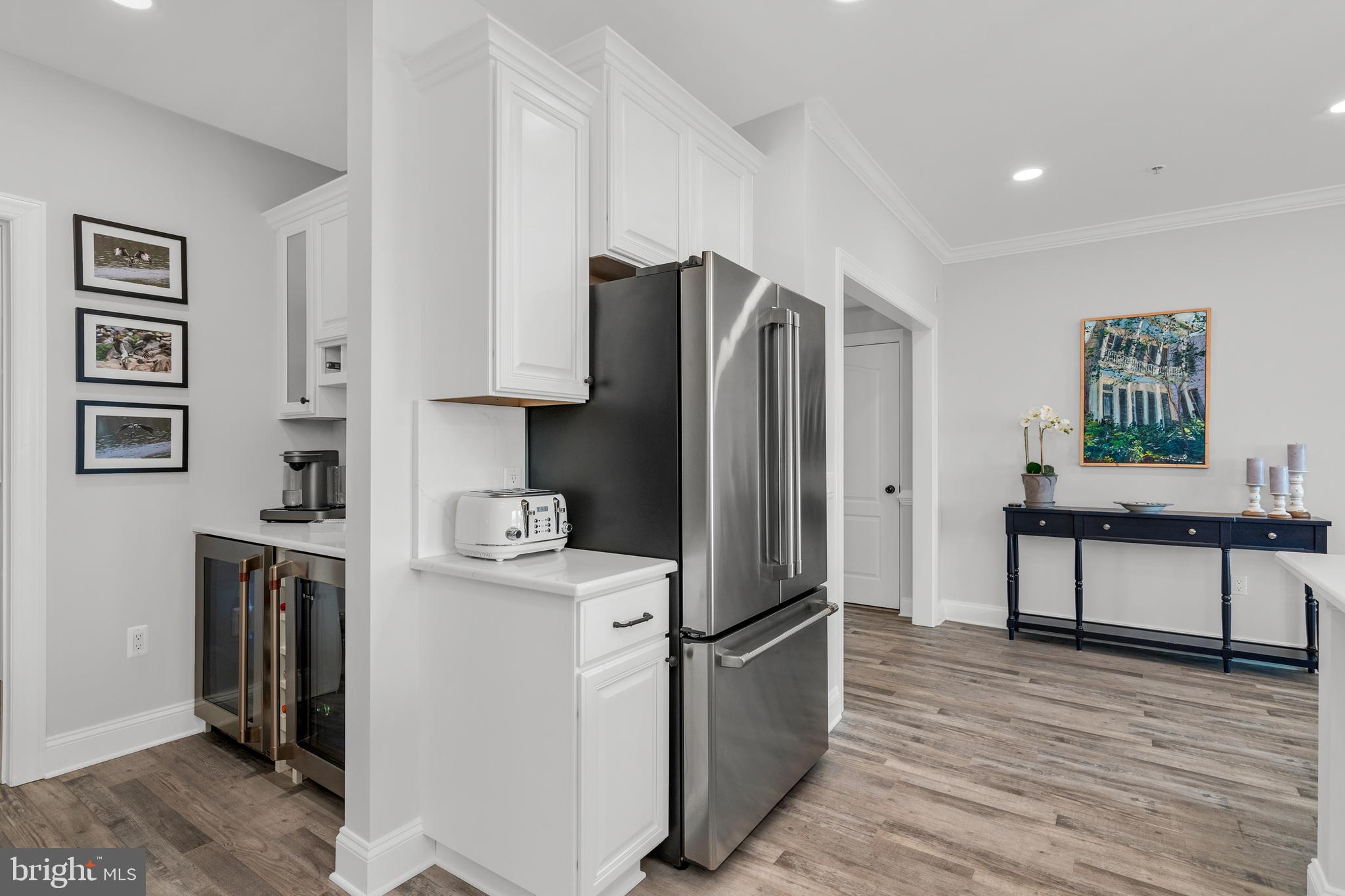 301 Muir Street, Unit 303 Cambridge, MD 21613 - Photo 12 of 36 a kitchen with stainless steel appliances a refrigerator stove and sink