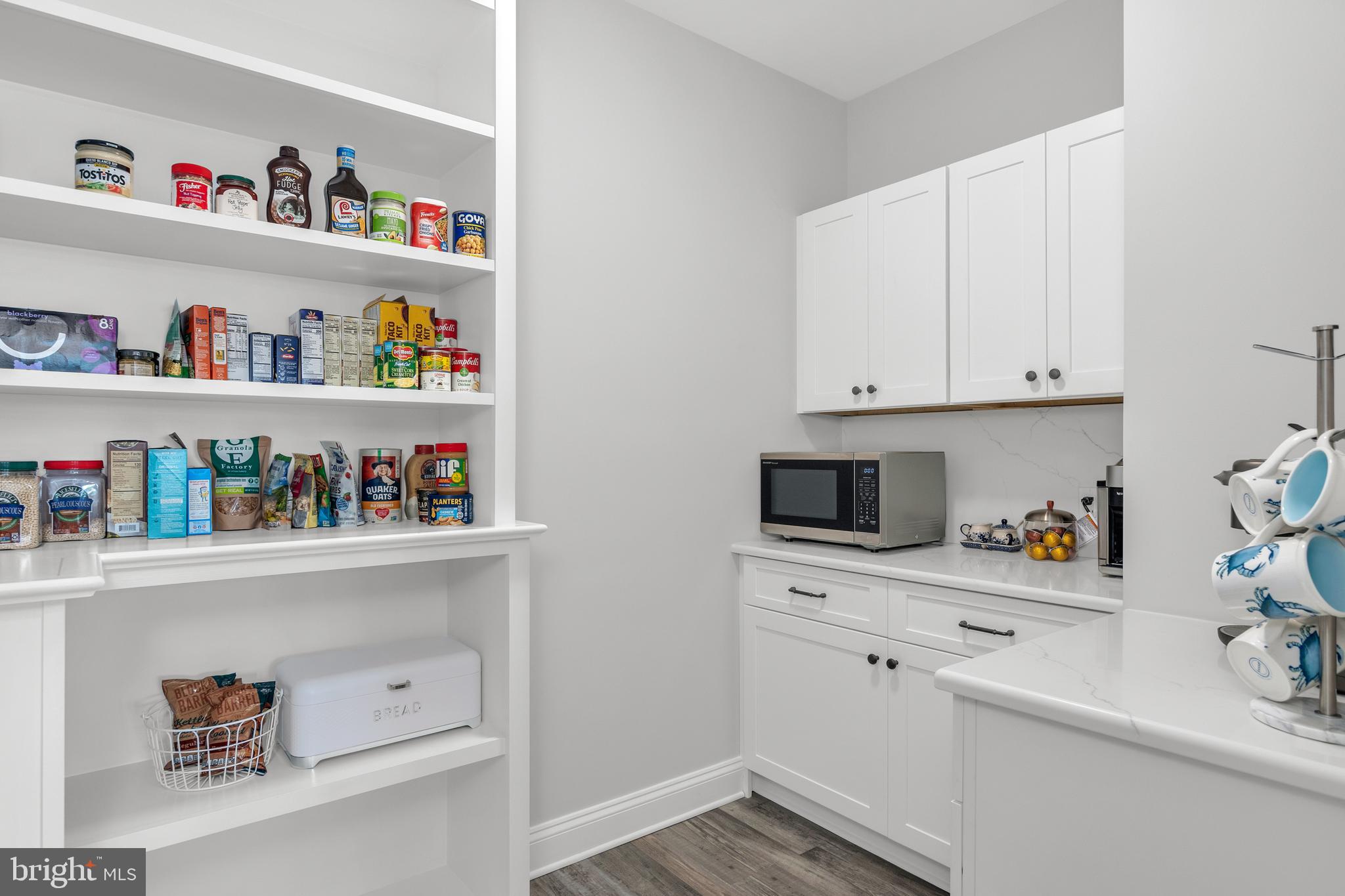 301 Muir Street, Unit 303 Cambridge, MD 21613 - Photo 19 of 36 a view of cabinets and wooden floor