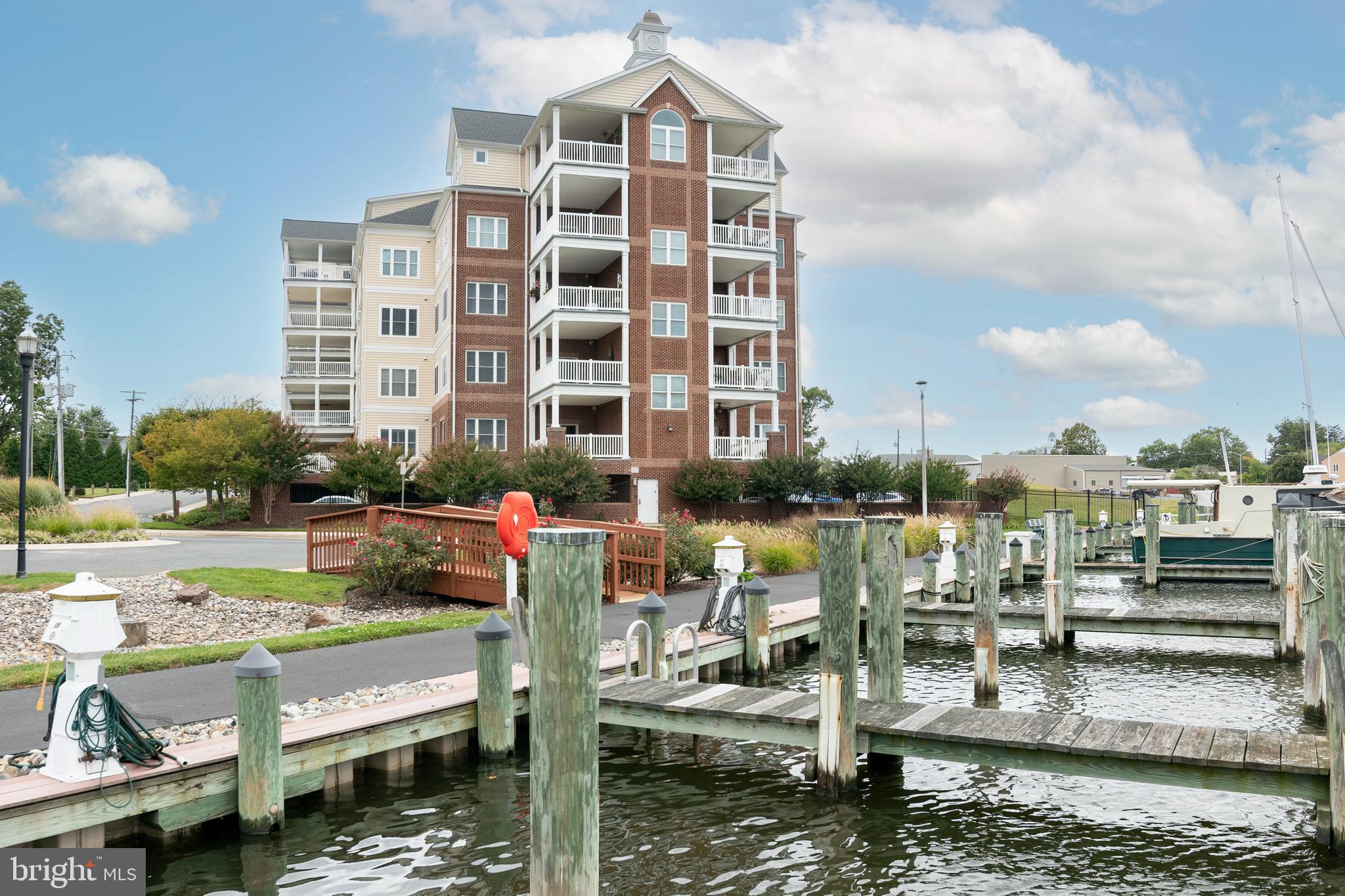 301 Muir Street, Unit 303 Cambridge, MD 21613 - Photo 2 of 36 a view of swimming pool with outdoor seating and city view