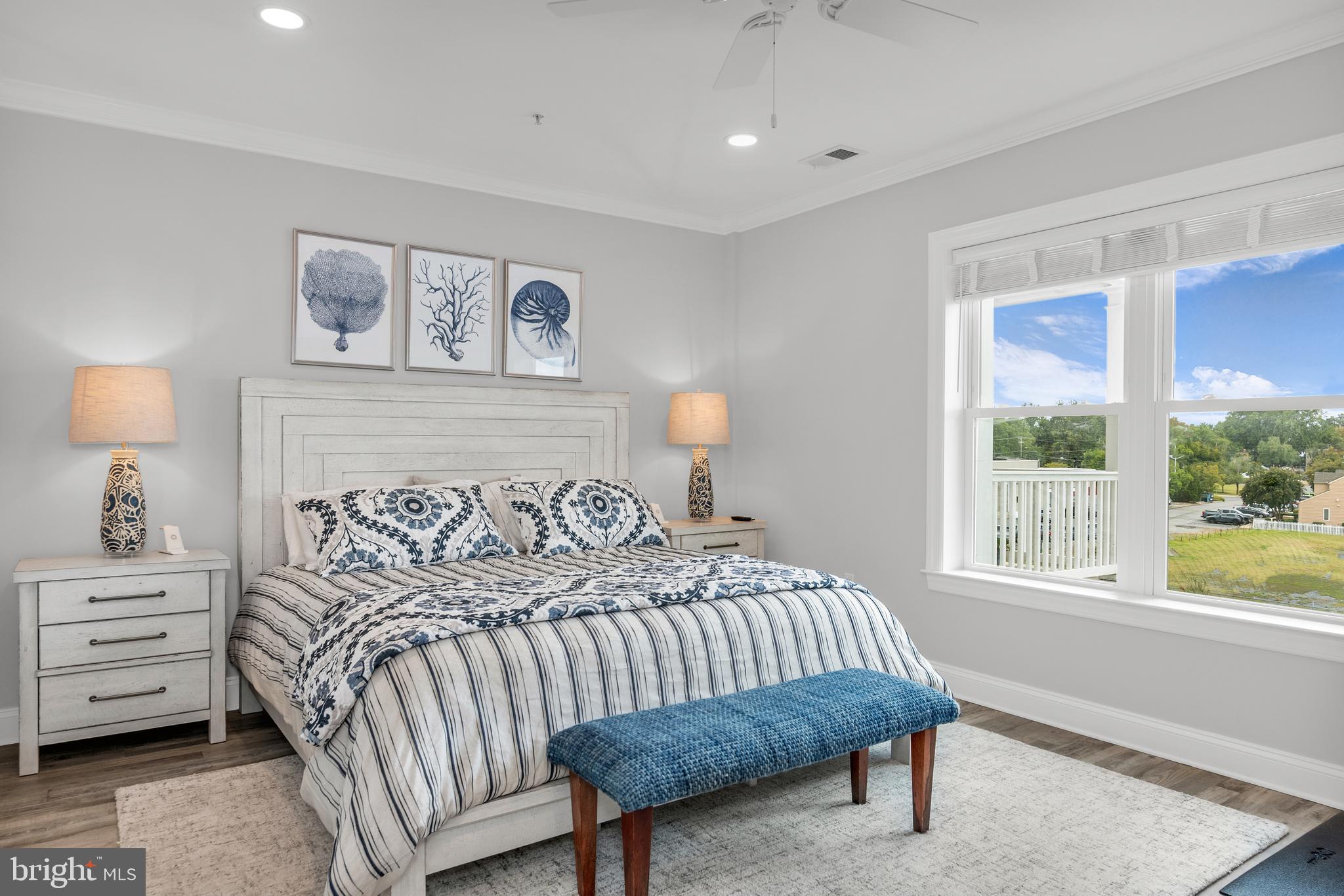 301 Muir Street, Unit 303 Cambridge, MD 21613 - Photo 22 of 36 a bedroom with a bed a couch and window