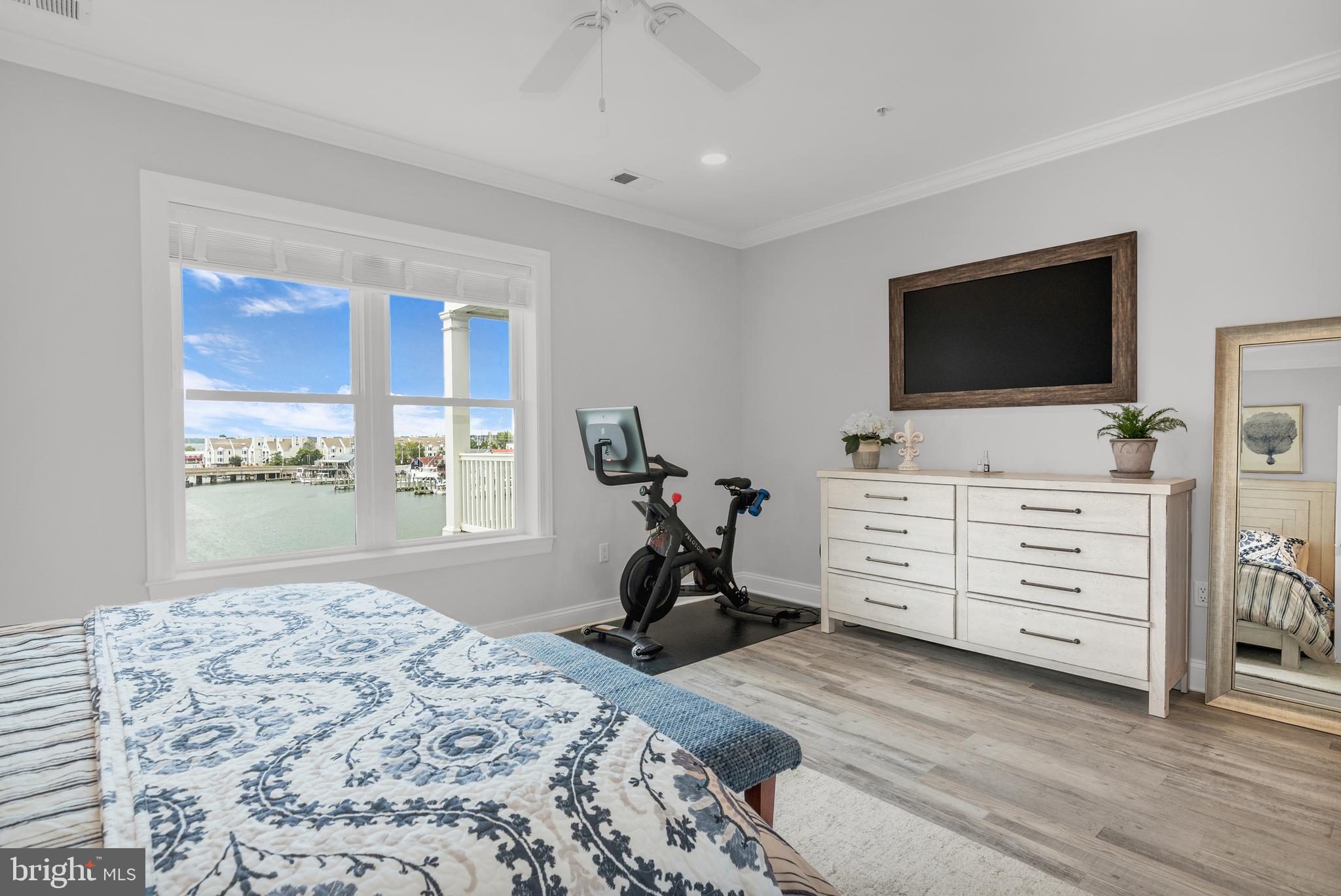 301 Muir Street, Unit 303 Cambridge, MD 21613 - Photo 23 of 36 a bedroom with furniture and a flat screen tv
