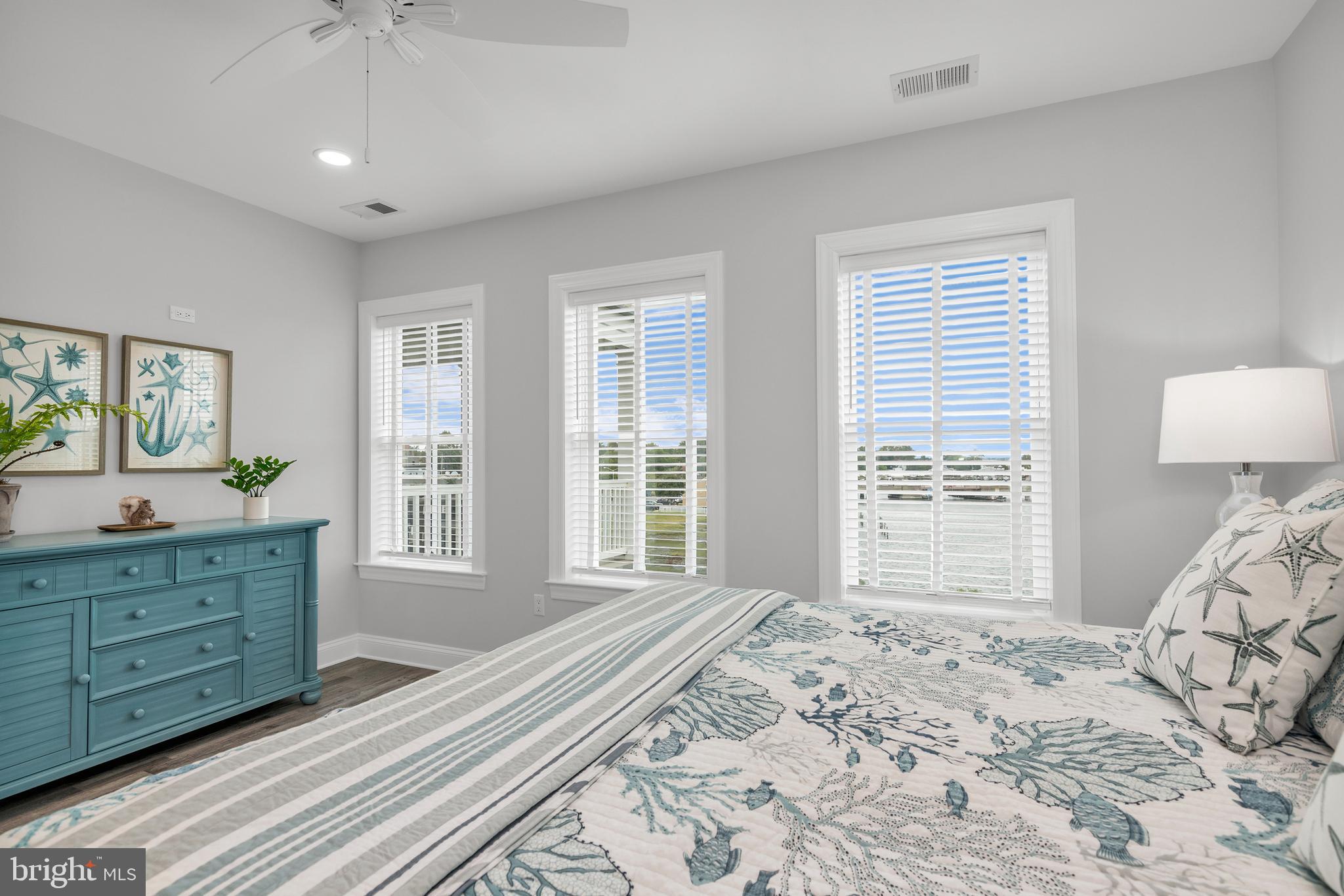 301 Muir Street, Unit 303 Cambridge, MD 21613 - Photo 27 of 36 a bedroom with a large bed and a window