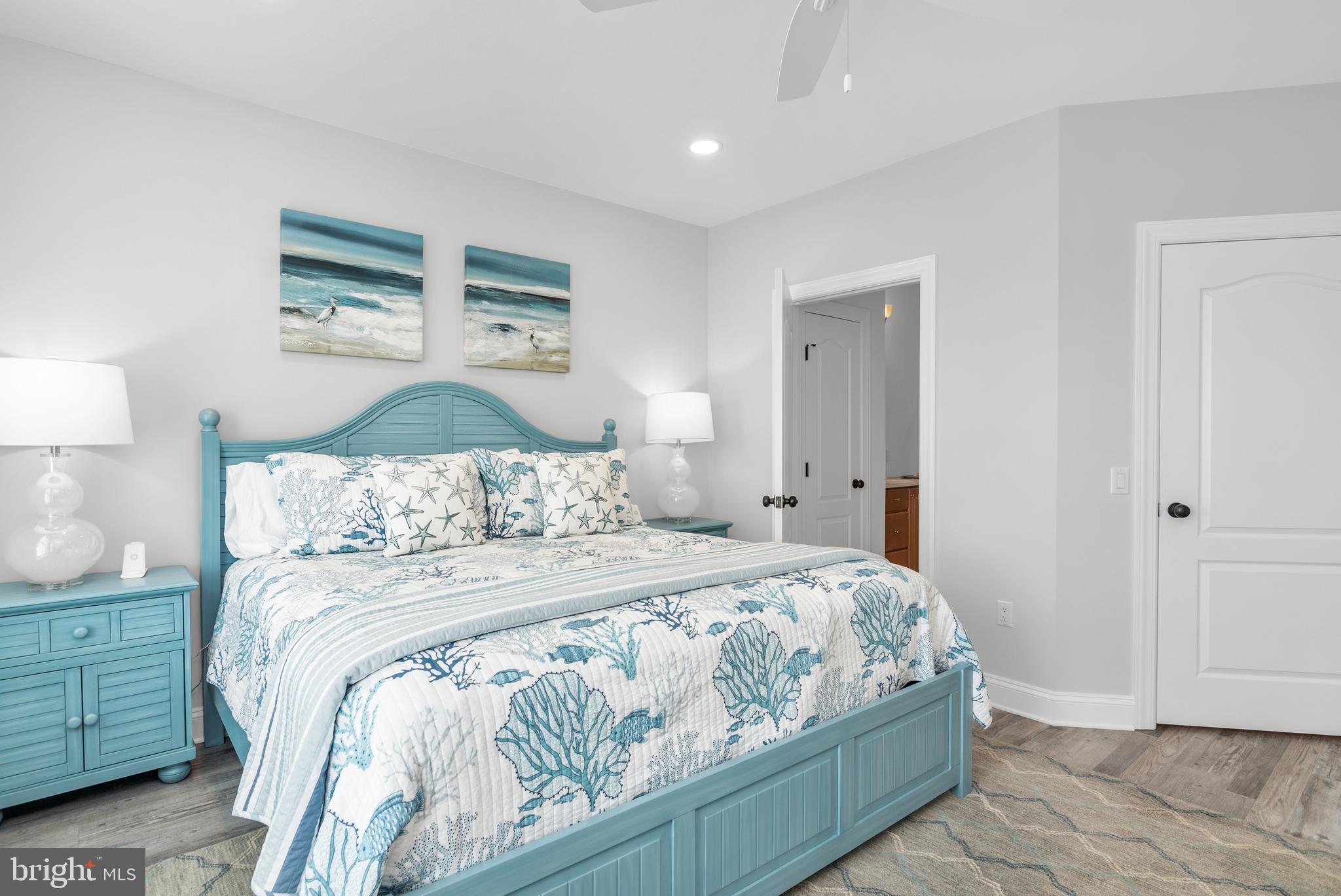 301 Muir Street, Unit 303 Cambridge, MD 21613 - Photo 29 of 36 a bedroom with a bed and a painting