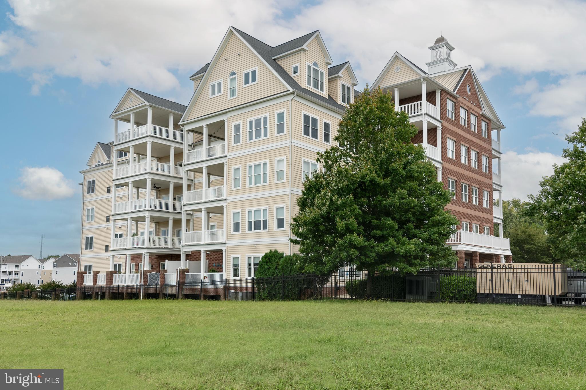 301 Muir Street, Unit 303 Cambridge, MD 21613 - Photo 35 of 36 a front view of a building with a garden