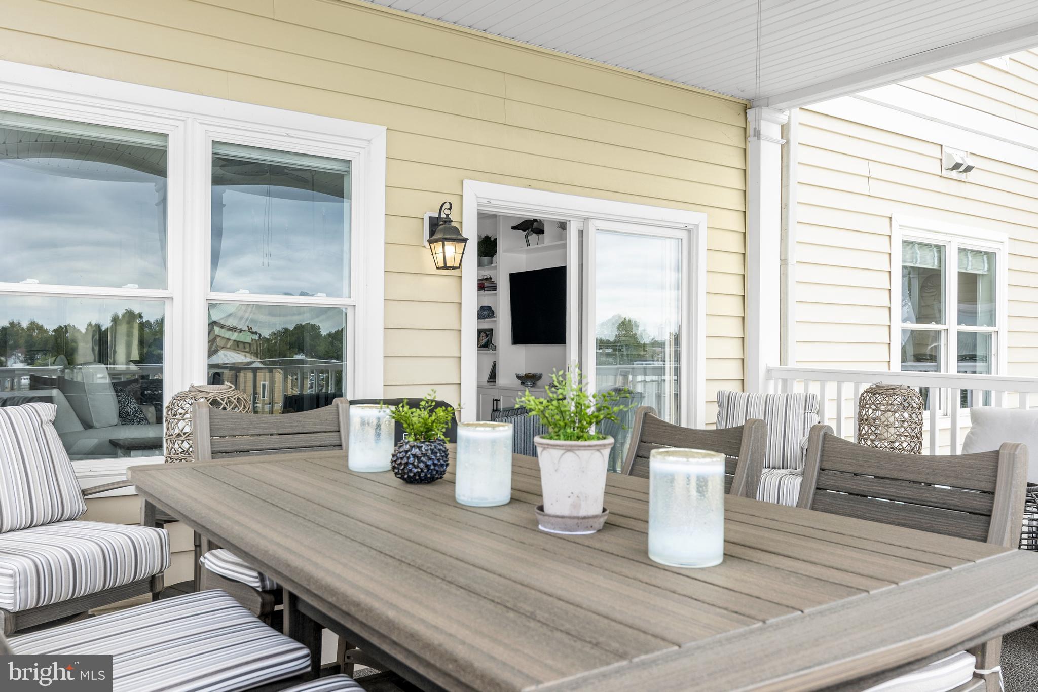301 Muir Street, Unit 303 Cambridge, MD 21613 - Photo 4 of 36 a dining room with furniture and wooden floor