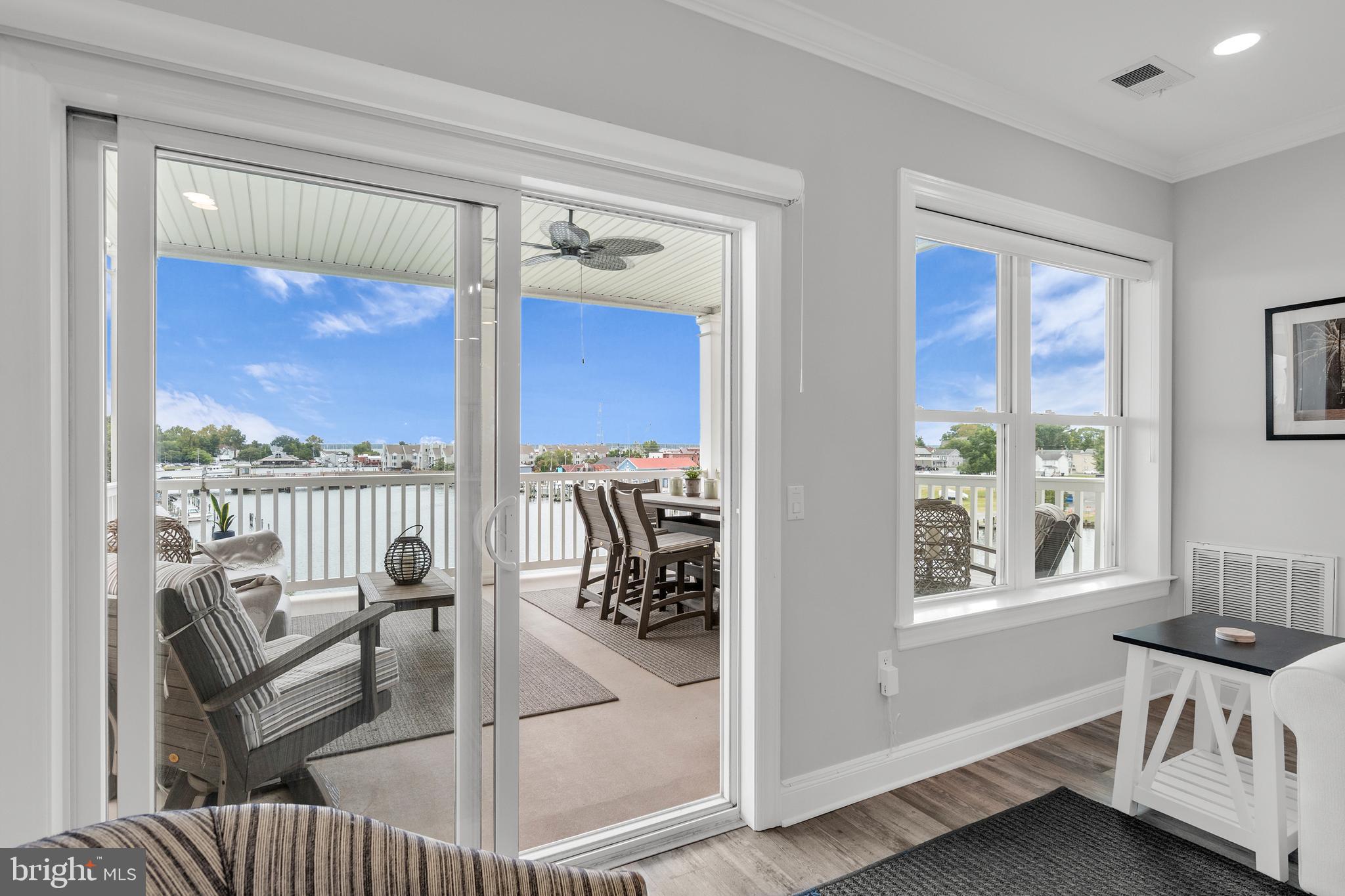 301 Muir Street, Unit 303 Cambridge, MD 21613 - Photo 6 of 36 a view of a living room and a balcony