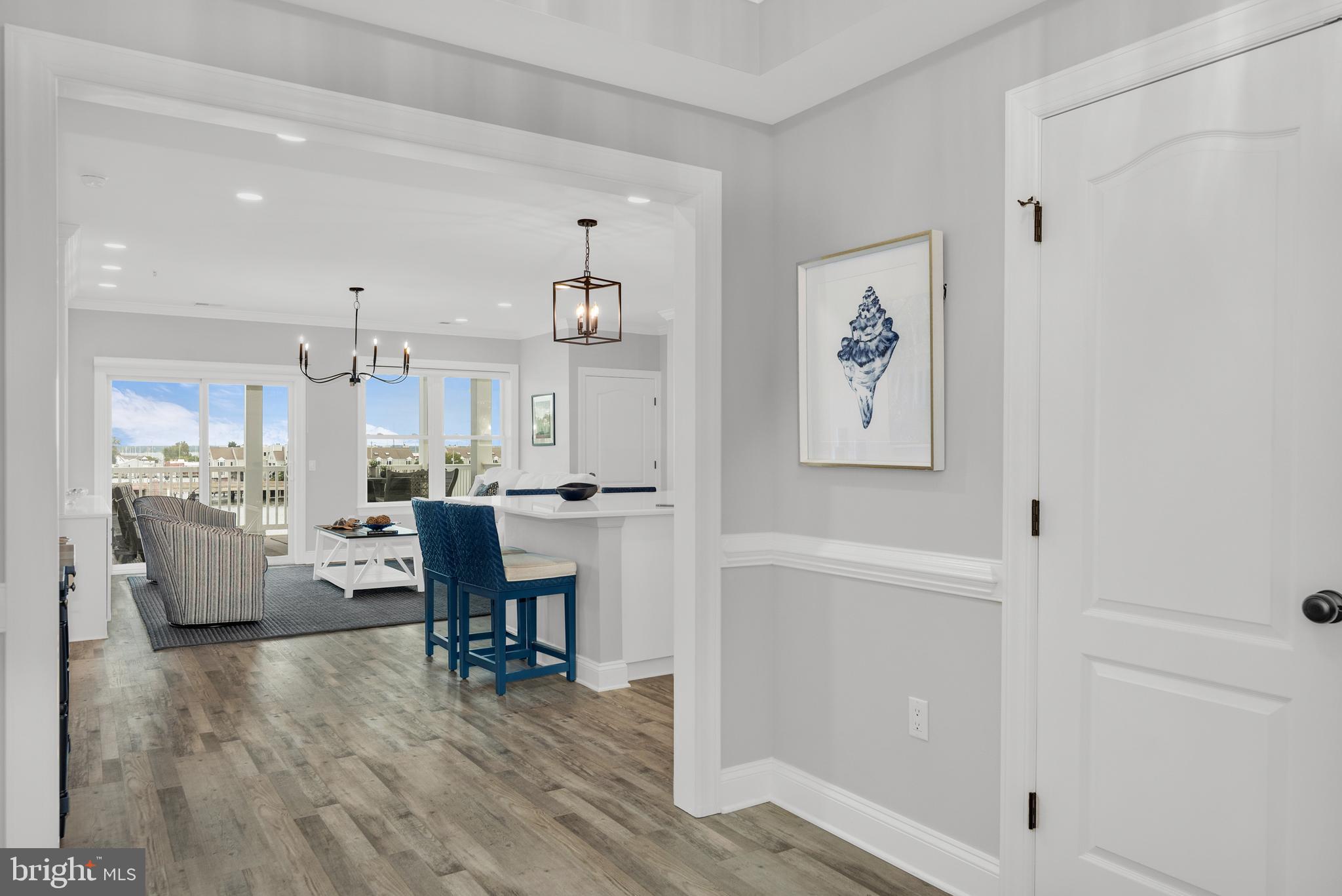 301 Muir Street, Unit 303 Cambridge, MD 21613 - Photo 8 of 36 a living room with furniture and a wooden floor