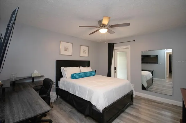 a bedroom with a bed and a flat screen tv