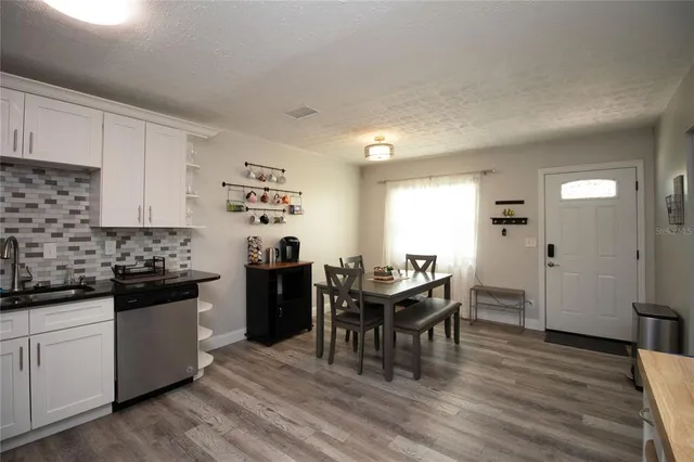 a kitchen with a table and chairs in it