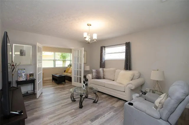 a living room with furniture and a chandelier